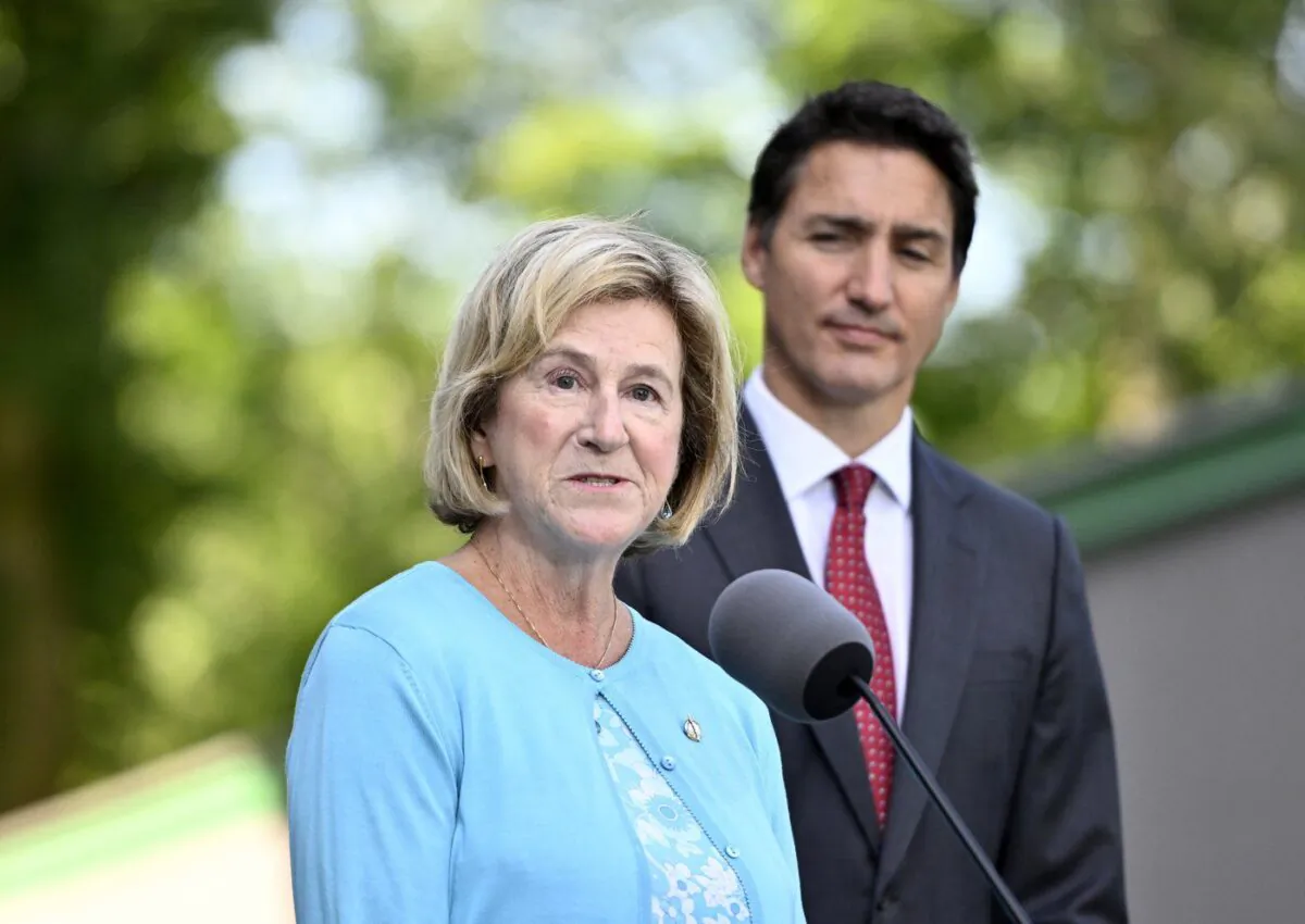 Minister of Public Services and Procurement Helena Jaczek speaks to reporters as Prime Minister Justin Trudeau looks on, at Rideau Hall in Ottawa, on Aug. 31, 2022. 
(The Canadian Press/Justin Tang)
