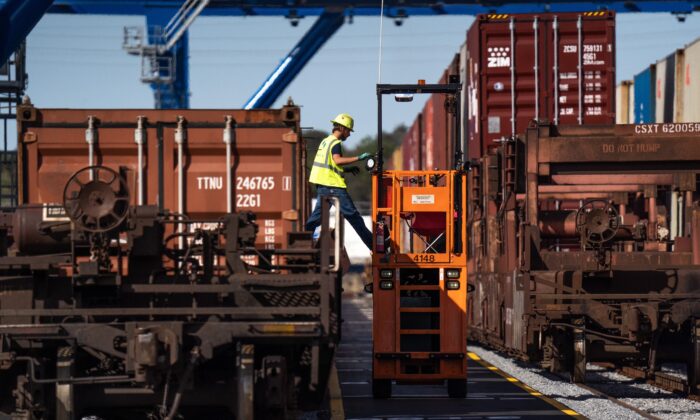 A worker tends to container loads at the Mason Mega Rail Station at the Garden City Port Terminal in Garden City, Ga., on Nov. 12, 2021. (Sean Rayford/Getty Images)