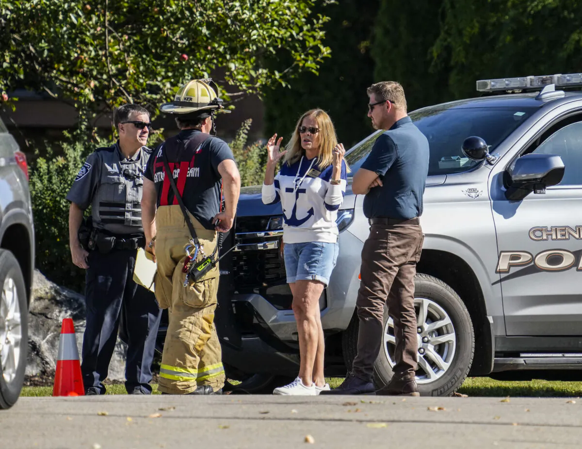 Hartland Fire Department Deputy Chief Peter Walker, speaks with Village Trustee Ann Wallschlager and Village President Jeffrey Pfannerstill at the scene of a fire in Hartland, Wis., on Oct. 21, 2022. (Scott Ash/Milwaukee Journal-Sentinel via AP)