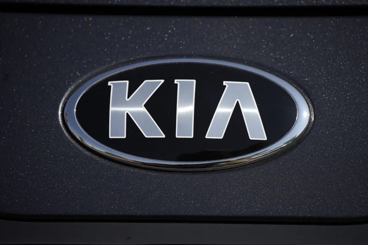 The company logo shines off the hood of a 2021 K5 sedan on display in the Kia exhibit at the Denver auto show in downtown Denver on Sept. 17, 2021. (David Zalubowski/AP Photo)