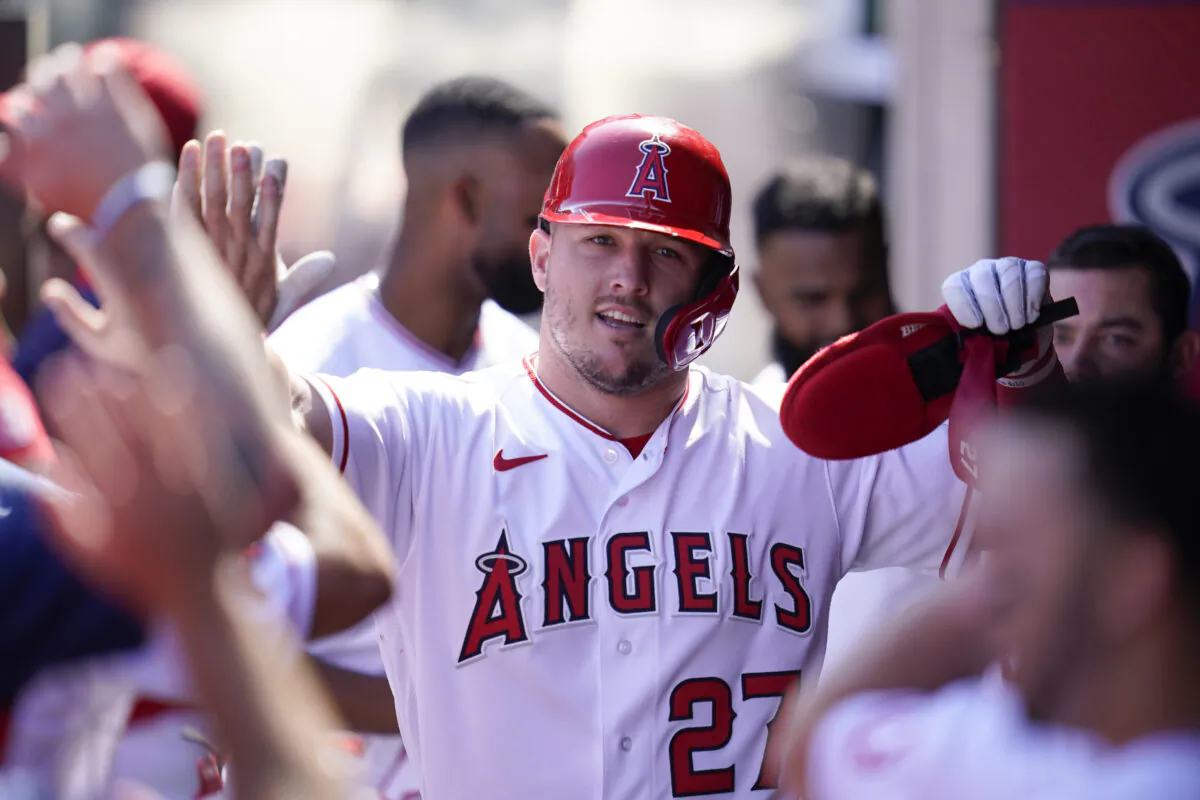 Los Angeles Angels' Mike Trout (27) celebrates in the dugout after scoring off of a single hit by Taylor Ward during the first inning of a baseball game against the Texas Rangers in Anaheim, Calif., on Oct. 2, 2022. (Ashley Landis/AP Photo)