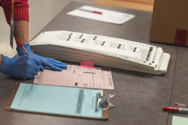 A poll worker handles ballots
