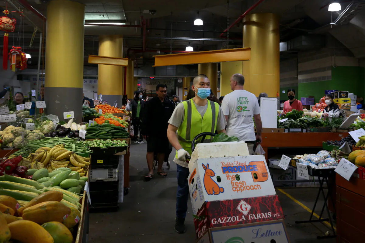 A store worker delivers fruit and vegetable produce at Paddy's Market in Sydney, Australia, on Oct. 22, 2022. (Lisa Maree Williams/Getty Images)