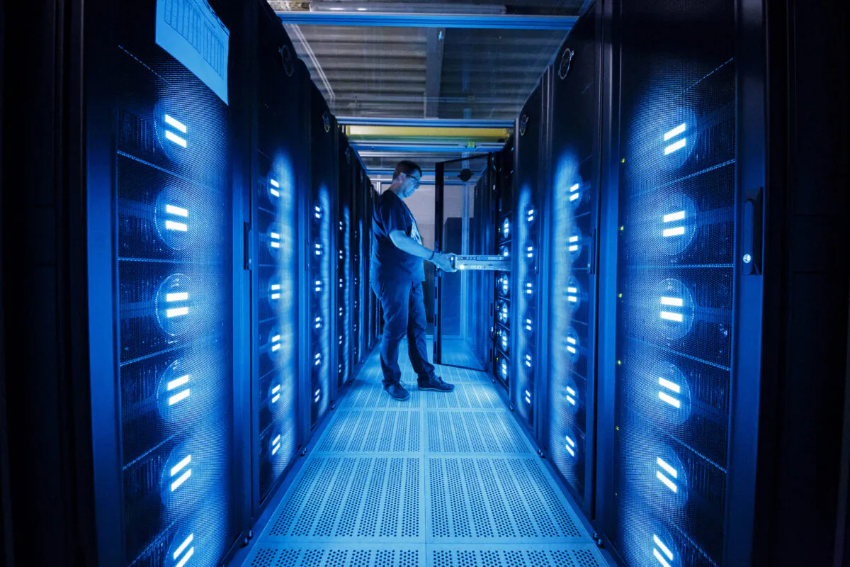 An employee of the German Climate Computing Center DKRZ (Deutsches Klimarechenzentrum) checks the Mistral supercomputer, installed in 2016, at the German Climate Computing Center on June 7, 2017, in Hamburg, Germany. (Morris MacMatzen/Getty Images)