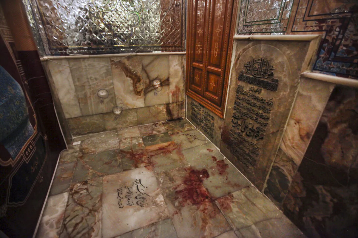 Bullet holes on the wall and blood on the ground after gunmen attacked the Shah Cheragh shrine in the southern city of Shiraz, Iran, on Oct. 26, 2022. (Mohammadreza Dehdari/Iranian Students' News Agency, ISNA via AP)