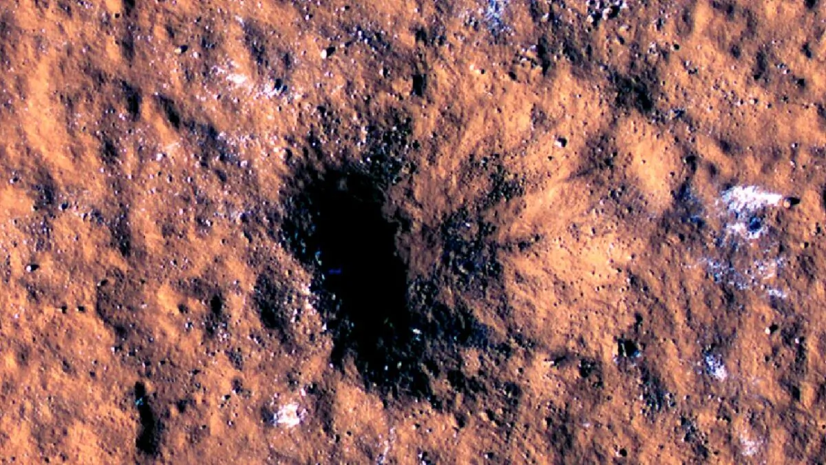Boulder-size blocks of water ice around the rim of an impact crater on Mars, as viewed by the High-Resolution Imaging Science Experiment (HiRISE camera) aboard NASA's Mars Reconnaissance Orbiter, in this image made available by NASA on Oct. 27, 2022. (NASA/JPL-Caltech/University of Arizona via AP)