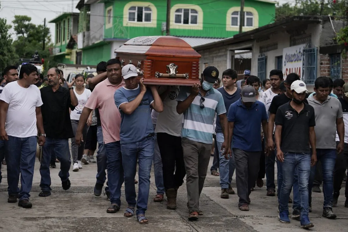 Residents carry the coffin of Wilmer Rojas the day after he was killed in a mass shooting in San Miguel Totolapan, Mexico, on Oct. 6, 2022. (Eduardo Verdugo/AP Photo)