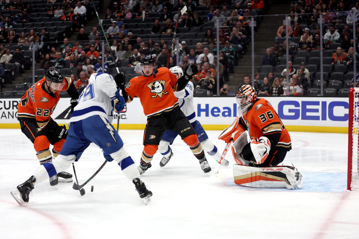 Simon Benoit (13) of the Anaheim Ducks checks Cole Koepke (45) of the Tampa Bay Lightning during the first period of a game at Honda Center in Anaheim, Calif., on Oct. 26, 2022. (Sean M. Haffey/Getty Images)