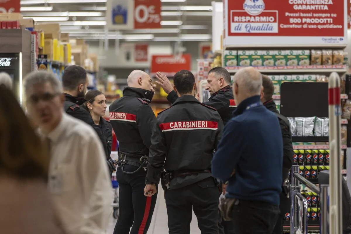 Police officers arrive to the scene of an attack in Milan on Oct. 27, 2022. (LaPresse via AP)