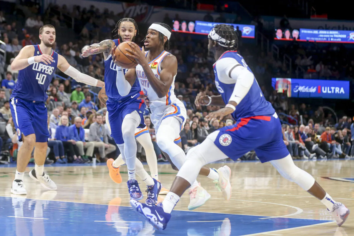 Shai Gilgeous-Alexander (2) of the Oklahoma City Thunder drives against Amir Coffey (7) and Reggie Jackson #1 of the Los Angeles Clippers during the third quarter at Paycom Center John Wall (11) of the Los Angeles Clippers dribbles the ball up court during the second quarter against the Oklahoma City Thunder at Paycom Center in Oklahoma City,  on Oct. 25, 2022. (Ian Maule/Getty Images)