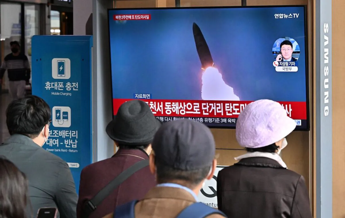 People watch a television screen showing a news broadcast with file footage of a North Korean missile test, at a railway station in Seoul, South Korea, on Oct. 28, 2022. (Jung Yeon-je/AFP via Getty Images)