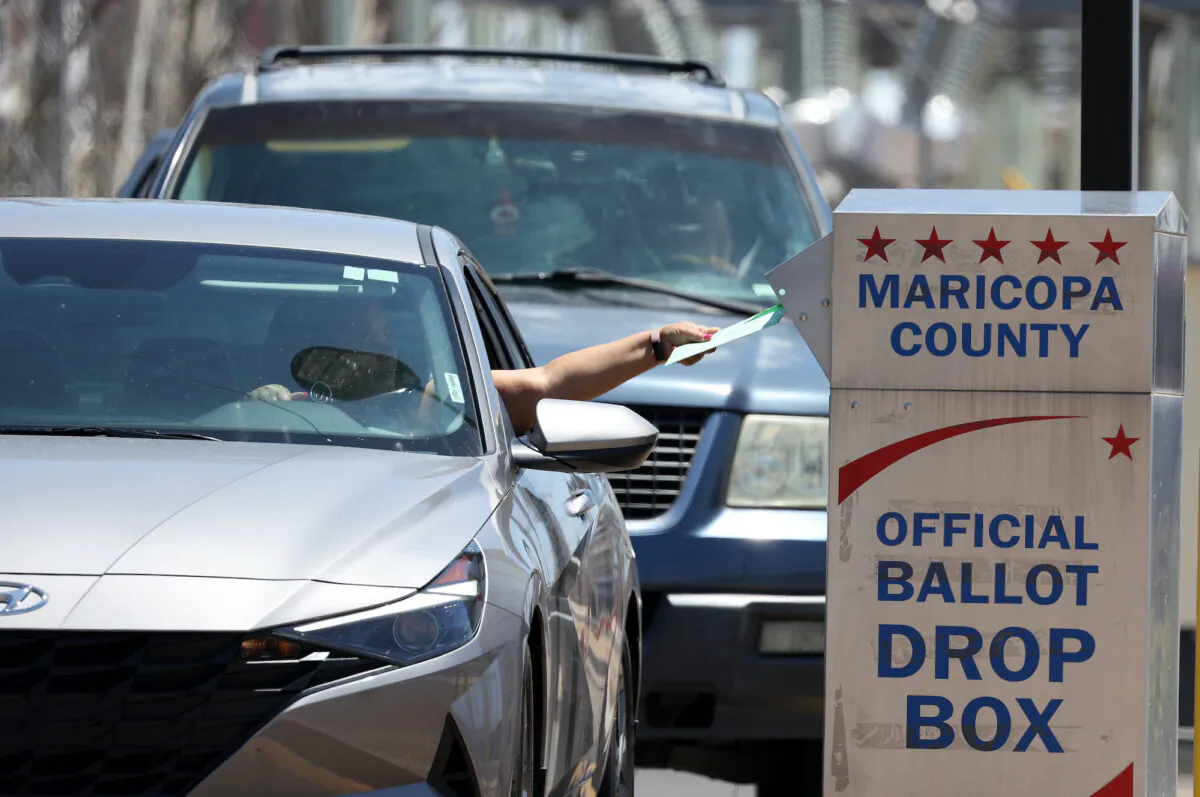 A voter places a ballot in a drop box outside of the Maricopa County Elections Department in Phoenix, Arizona, on Aug. 2, 2022. (Justin Sullivan/Getty Images)