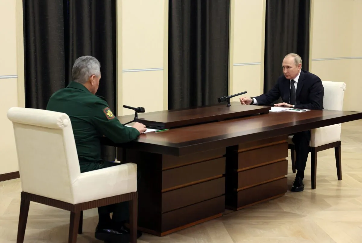 Russian President Vladimir Putin (R) attends a meeting with Defense Minister Sergei Shoigu at the Novo-Ogaryovo state residence, outside Moscow, on Oct. 28, 2022. (Sputnik/Mikhail Metzel/Handout via Reuters)
