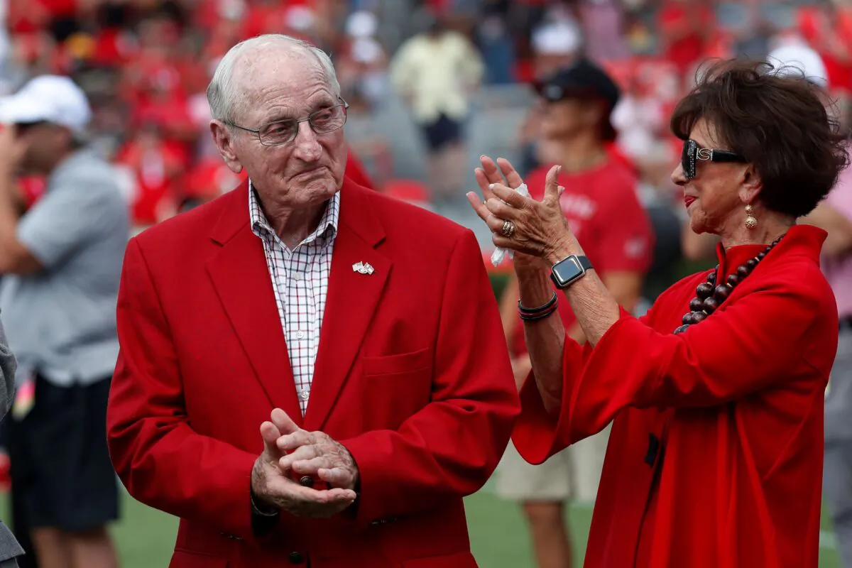 Former head Georgia football coach and athletic director Vince Dooley and his wife Barbara react during a ceremony to name the field at Sanford Stadium in his honor before an NCAA college football game against the Murray State in Athens, Ga., on Sept. 7, 2019.(John Bazemore/AP Photo)