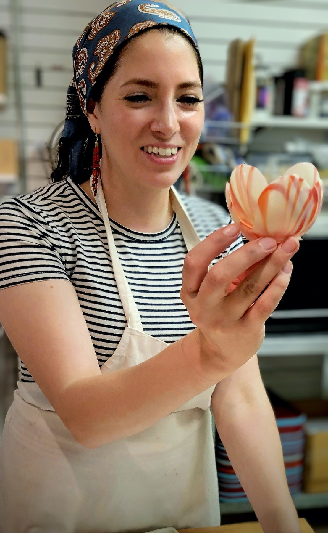A chocolatier holding an edible flower