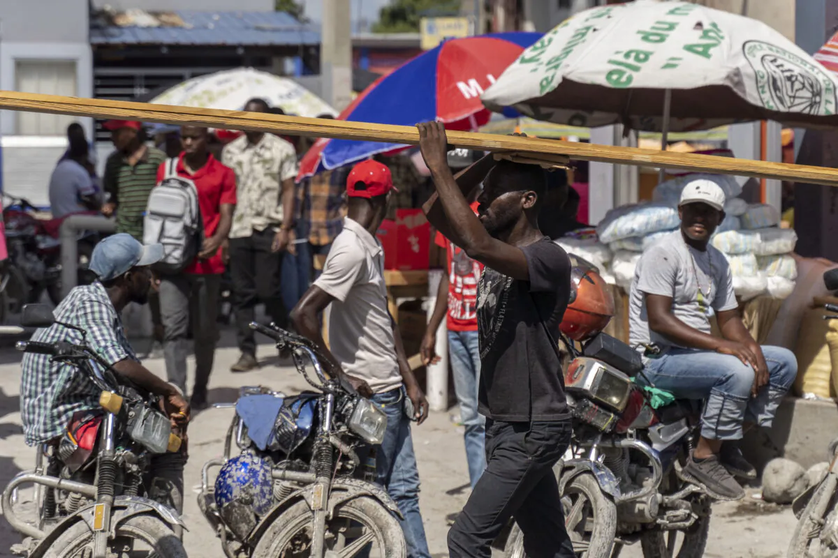 Haitians work in Port-au-Prince on Oct. 29, 2022, one day after gunmen assassinated former presidential candidate Eric Jean Baptiste, secretary-general of the Rally of Progressive National Democrats. (Richard Pierrin/AFP via Getty Images)