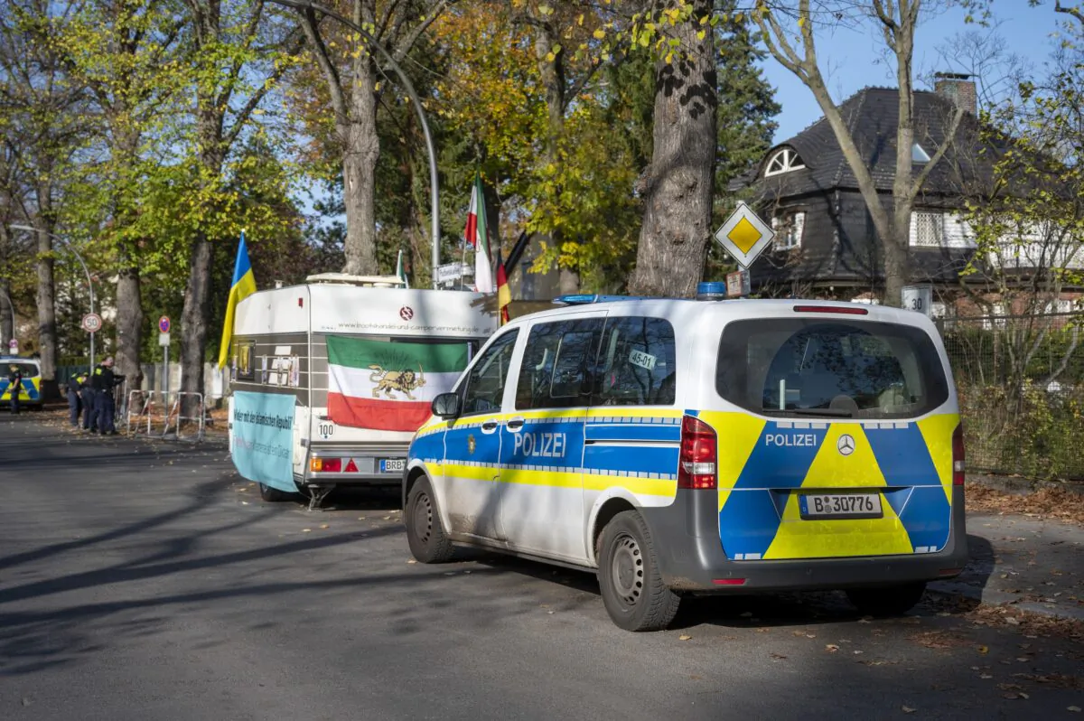 A protest camp of activists demonstrating against the Iranian regime stands behind a police car and in front of the Iranian Embassy in Berlin on Oct. 30, 2022. (Christophe Gateau/dpa via AP)