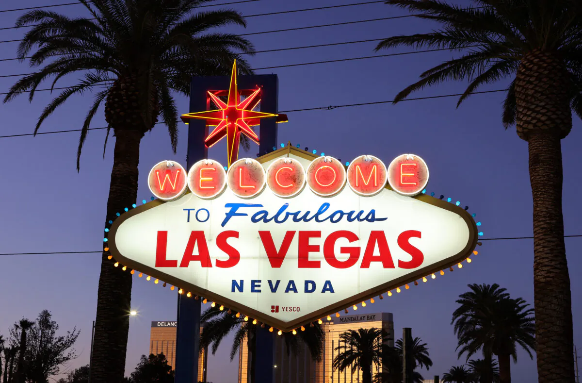 Blue and yellow lights flicker along the border of the famous welcome sign on the Las Vegas Strip in Las Vegas on Feb. 28, 2022. (Ethan Miller/Getty Images)