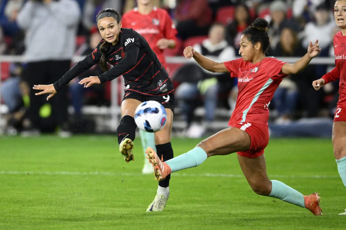 Portland Thorns FC forward Sophia Smith (L) kicks the ball against Kansas City Current defender Addisyn Merrick (R) during the first half of the NWSL championship soccer match in Washington on Oct. 29, 2022. (Nick Wass/AP Photo)