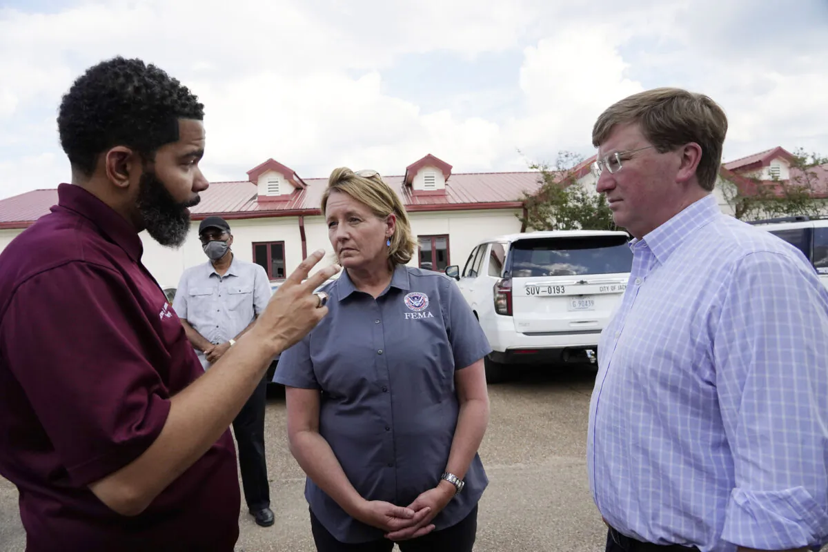 Deanne Criswell (C), administrator of the Federal Emergency Management Agency (FEMA), and Mississippi Gov. Tate Reeves (R) confer with Jackson Mayor Chokwe Antar Lumumba following a tour the City of Jackson's O.B. Curtis Water Treatment Facility in Ridgeland, Miss., on Sept. 2, 2022. (Rogelio V. Solis/AP Photo)