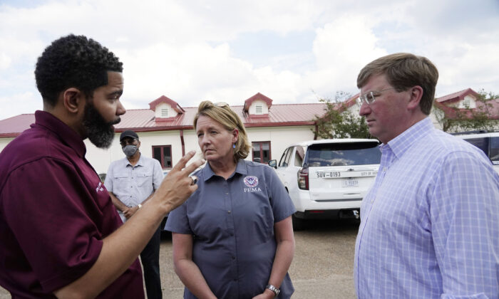 Deanne Criswell, administrator of the Federal Emergency Management Agency (FEMA), center, and Mississippi Gov. Tate Reeves, right, confer with Jackson Mayor Chokwe Antar Lumumba following a tour the City of Jackson's O.B. Curtis Water Treatment Facility in Ridgeland, Miss., Sept. 2, 2022. (Rogelio V. Solis, Pool/AP Photo)