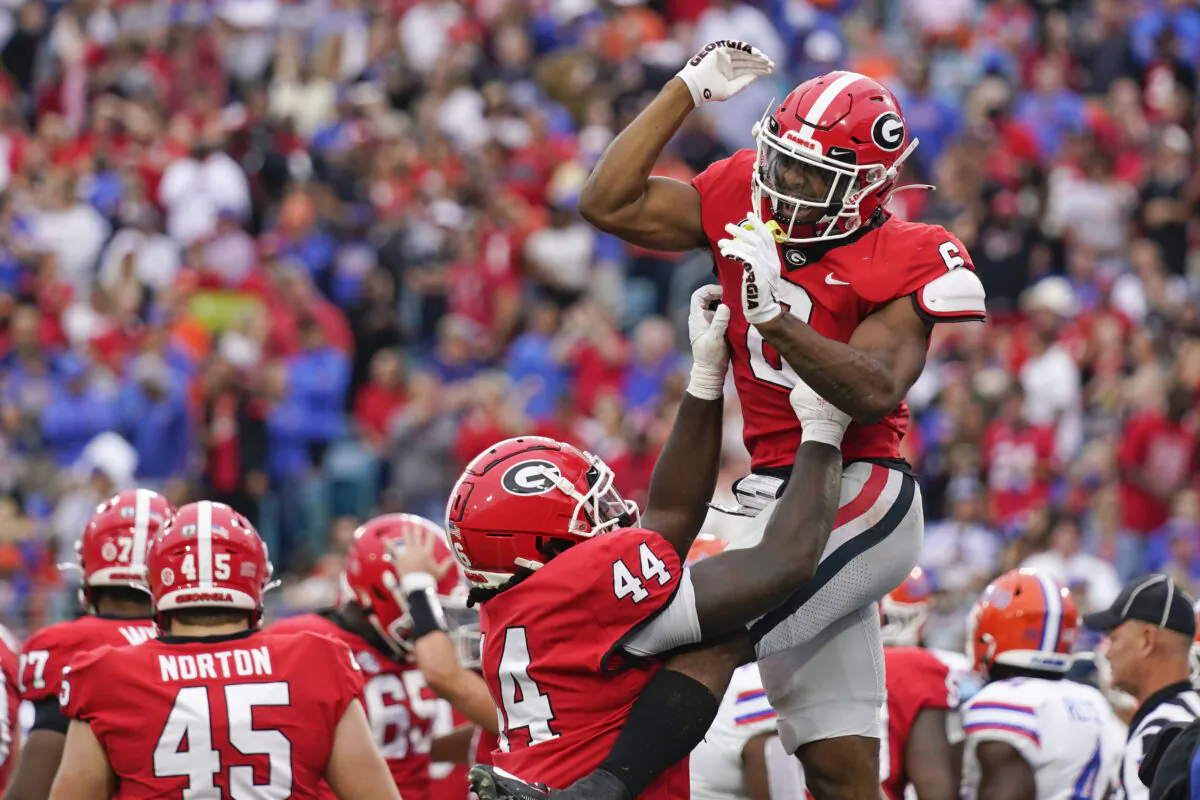 Georgia running back Kenny McIntosh, right, celebrates with teammate tight end Cade Brock (44) after scoring a touchdown against Florida during the first half of an NCAA college football game in Jacksonville, Flor., on Oct. 29, 2022. (John Raoux/AP Photo)