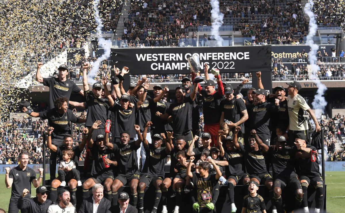 Carlos Vela (10) of Los Angeles FC holds the championship trophy as he celebrates with teammates after defeating Austin FC, 3-0, during the Western Conference Finals of the 2022 MLS Cup Playoffs at Banc of California Stadium in Los Angeles, on Oct. 30, 2022. (Kevork Djansezian/Getty Images)