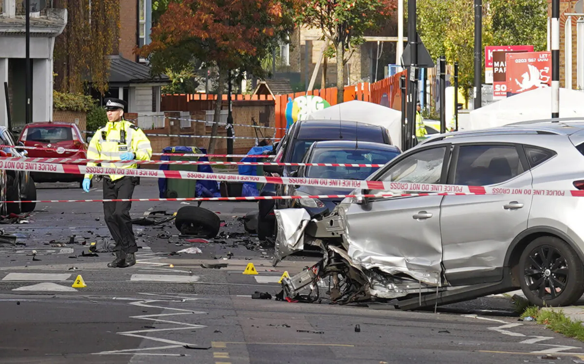 Police at the scene where two men were shot dead in Brixton, south London, on Oct. 31, 2022. (PA)