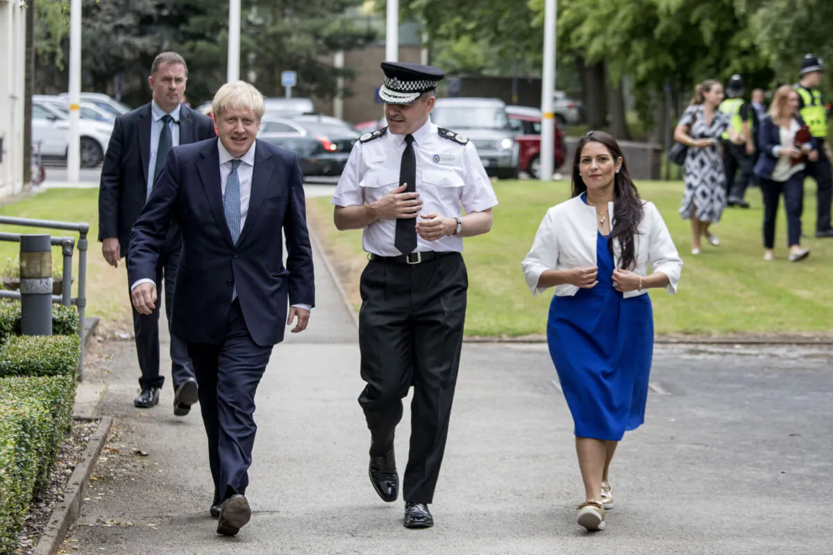 British Prime Minister Boris Johnson arrives with Home Secretary Priti Patel and Chief Constable David Thompson to speak to new graduates during a visit to the West Midlands Police Learning & Development Centre in Birmingham, England, on July 26, 2019. (Jack Hill - WPA Pool/Getty Images)