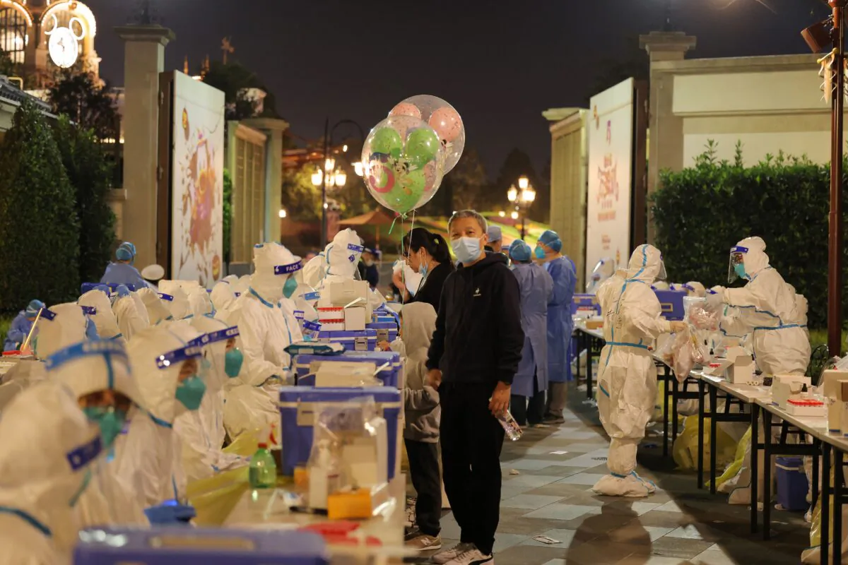 Medical personnel testing visitors for the Covid-19 coronavirus at Disneyland in Shanghai on October 31, 2021. (-/AFP via Getty Images)