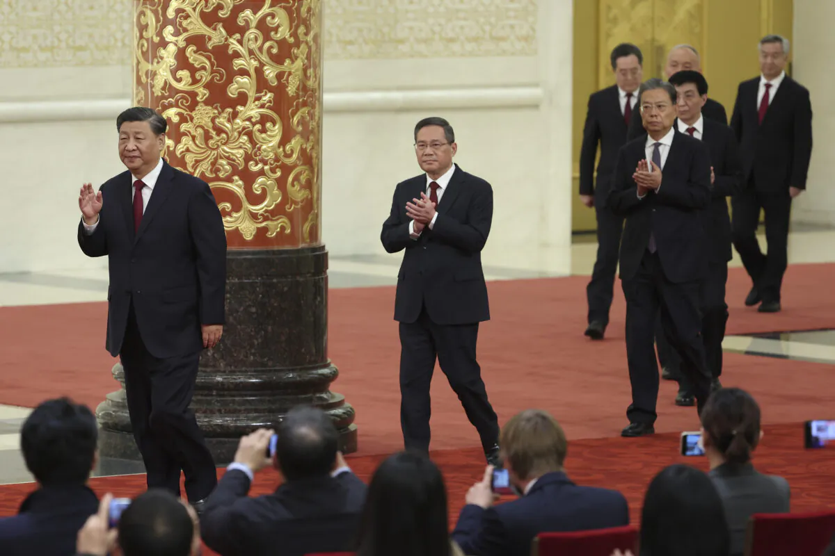 (L-R) Xi Jinping, Li Qiang, Zhao Leji, Wang Huning, Cai Qi, Ding Xuexiang and Li Xi, attend the meeting between members of the standing committee of the Political Bureau of the 20th CPC Central Committee and Chinese and foreign journalists at The Great Hall of People in Beijing, China, on Oct. 23, 2022. (Lintao Zhang/Getty Images)
