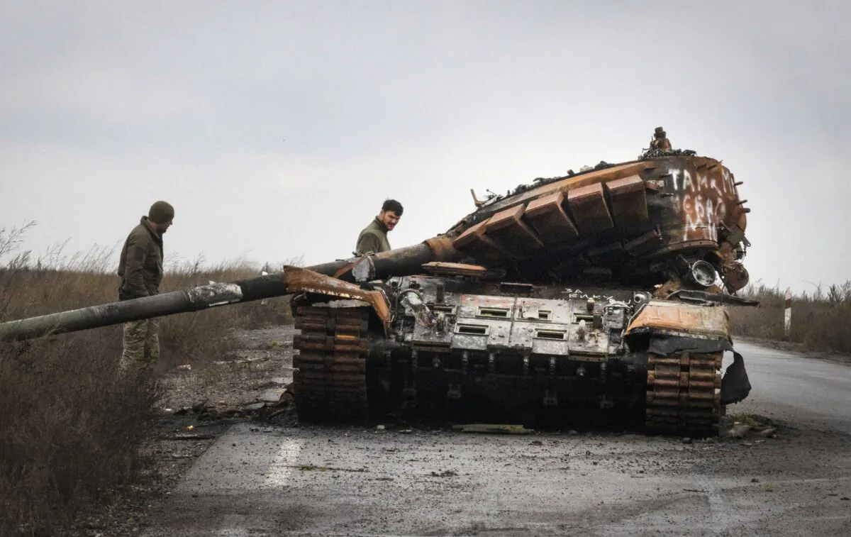 Ukrainian soldiers inspect a damaged Russian tank on a road near the recently retaken village of Kamianka, Kharkiv region, Ukraine, on Oct. 30, 2022. (Efrem Lukatsky/AP Photo)