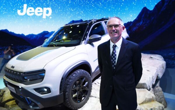 Stellantis CEO Carlos Tavares poses in front of Jeep