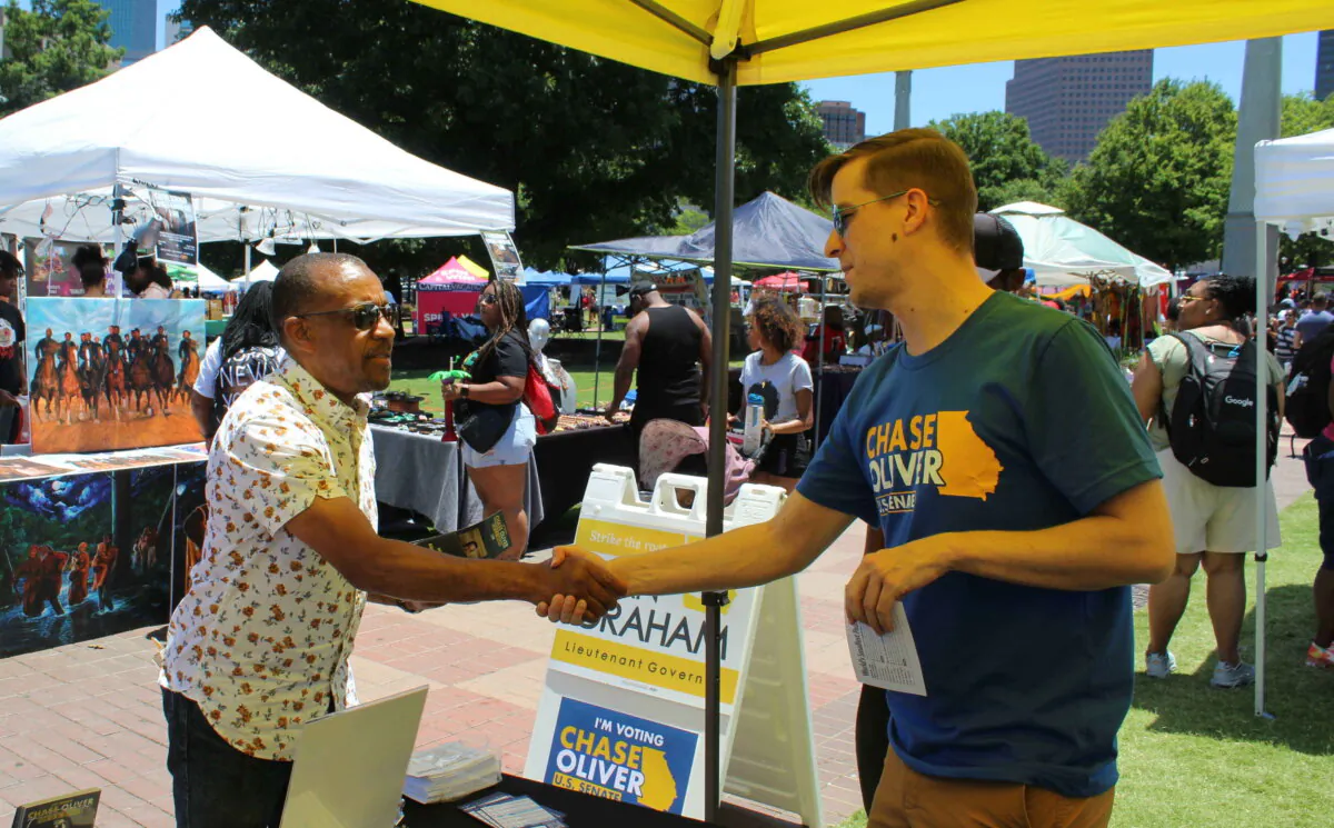 Chase Oliver, (R), Libertarian candidate for Georgia's U.S. Senate seat, on the campaign trail. He could get enough votes on Nov. 8 to send Republican Herschel Walker and Democrat incumbent Raphael Warnock to a runoff. (Courtesy of Chase Oliver campaign.) 