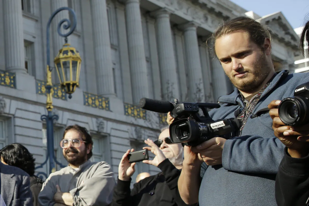 David DePape (R) records a wedding in San Francisco, Calif., on Dec. 19, 2013. (Eric Risberg/AP Photo)