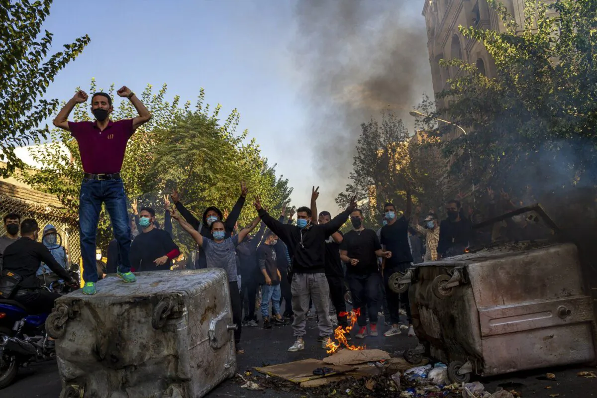 In this photo taken by an individual not employed by the Associated Press and obtained by the AP outside Iran, Iranians protests the death of 22-year-old Mahsa Amini after she was detained by the morality police last month, in Tehran, Oct. 27, 2022. (The Canadian Press/Middle East Images)