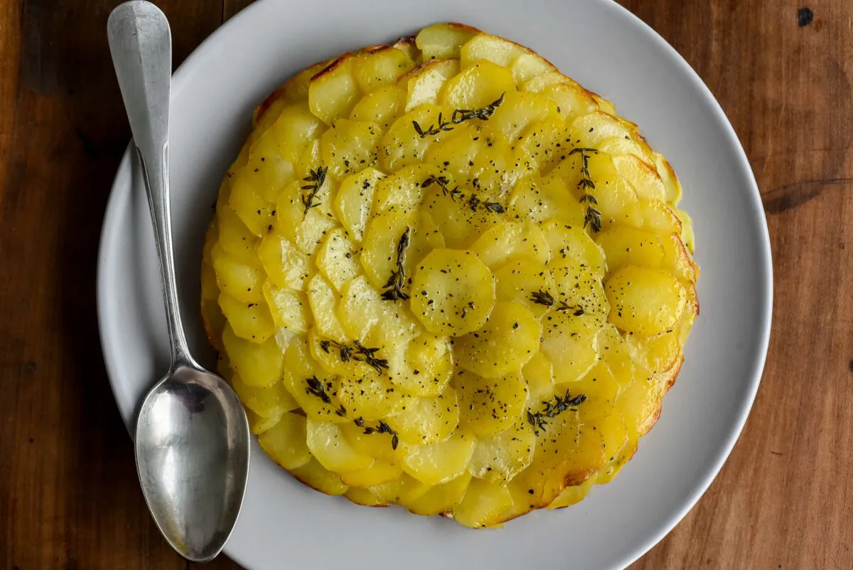 Pommes Anna layers humble potatoes and plenty of butter into a cake with crisp, golden edges and a buttery, melt-in-your-mouth center. (Audrey Le Goff)