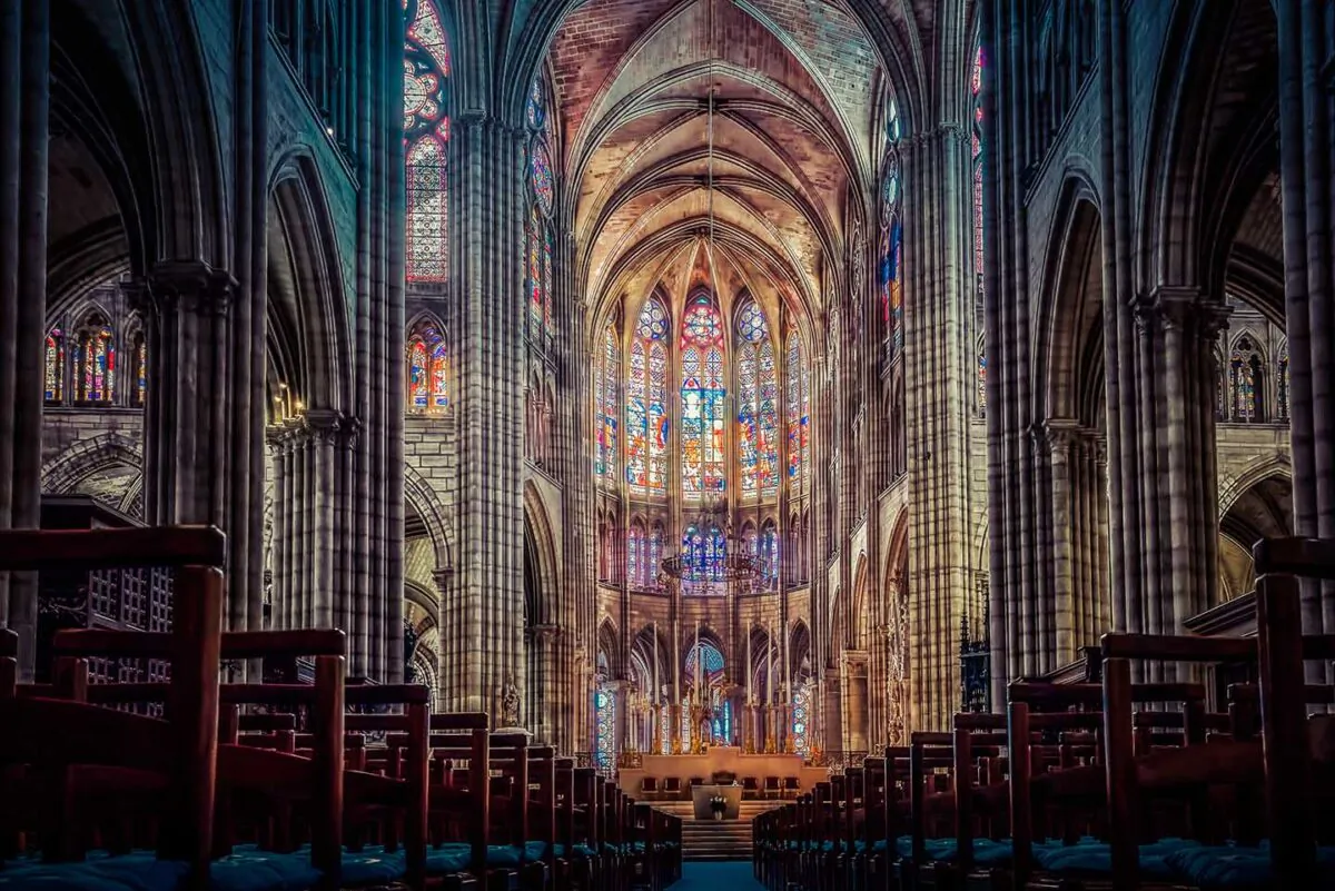 Abbot Suger carefully combined architectural elements from the styles of different French regions to create a dramatically new one—Gothic. Pictured here is the nave of the Basilica of Saint Denis, looking towards the choir. (Capture11Photography/Shutterstock)