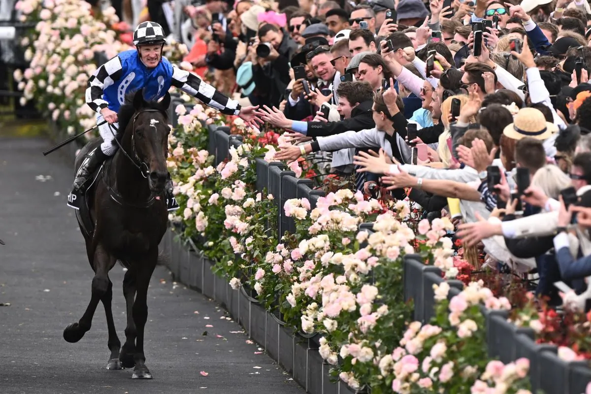 Jockey Mark Zahra celebrates after riding Gold Trip to win race seven, the Lexus Melbourne Cup during the 2022 Lexus Melbourne Cup at Flemington Racecourse in Melbourne, Tuesday, Nov. 1, 2022. (AAP Image/Joel Carrett)