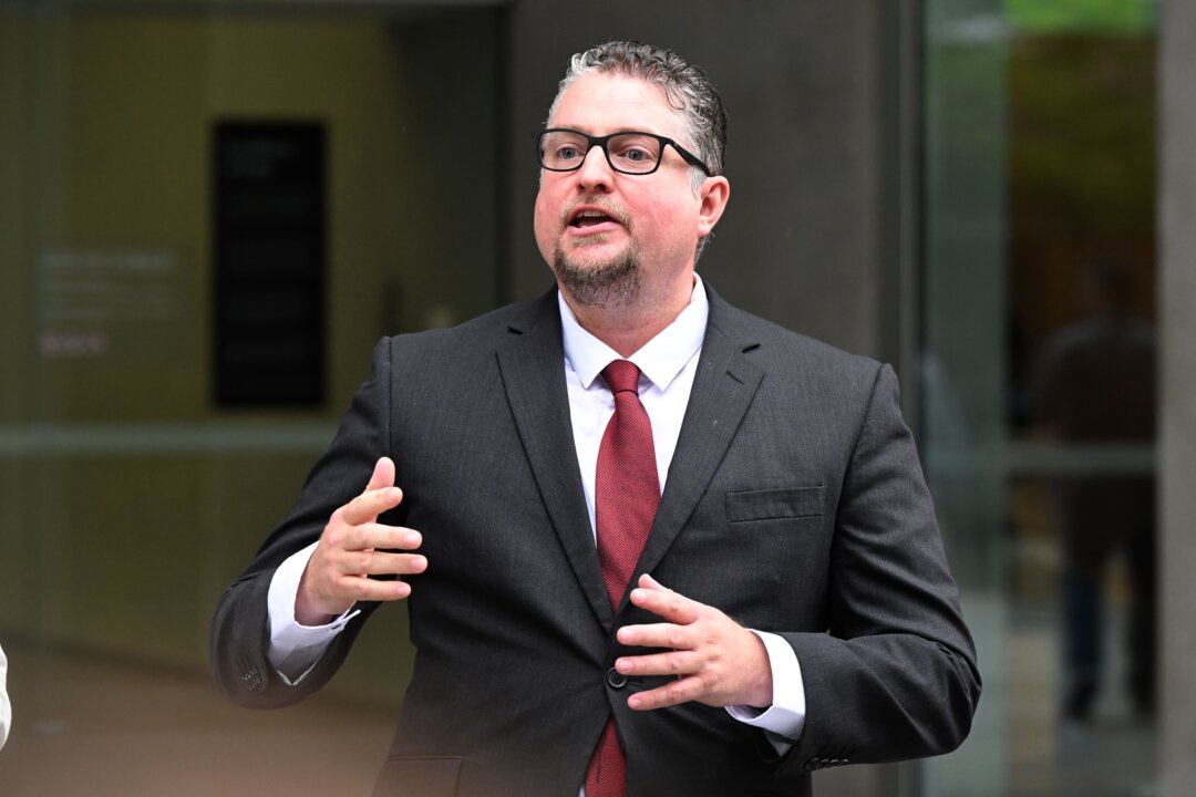 Dr William Bay is seen talking to his supporters outside the Brisbane Supreme Court in Brisbane, Australia, on Nov. 30, 2022. (AAP Image/Darren England)