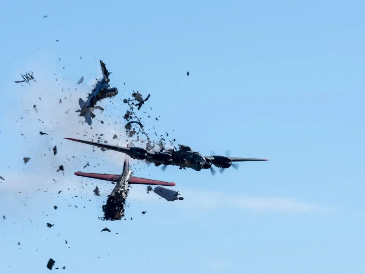 A Boeing B-17 Flying Fortress and a Bell P-63 Kingcobra collide in the midair during an airshow at Dallas Executive Airport in Dallas on Nov. 12, 2022. (Larry Petterborg via AP)