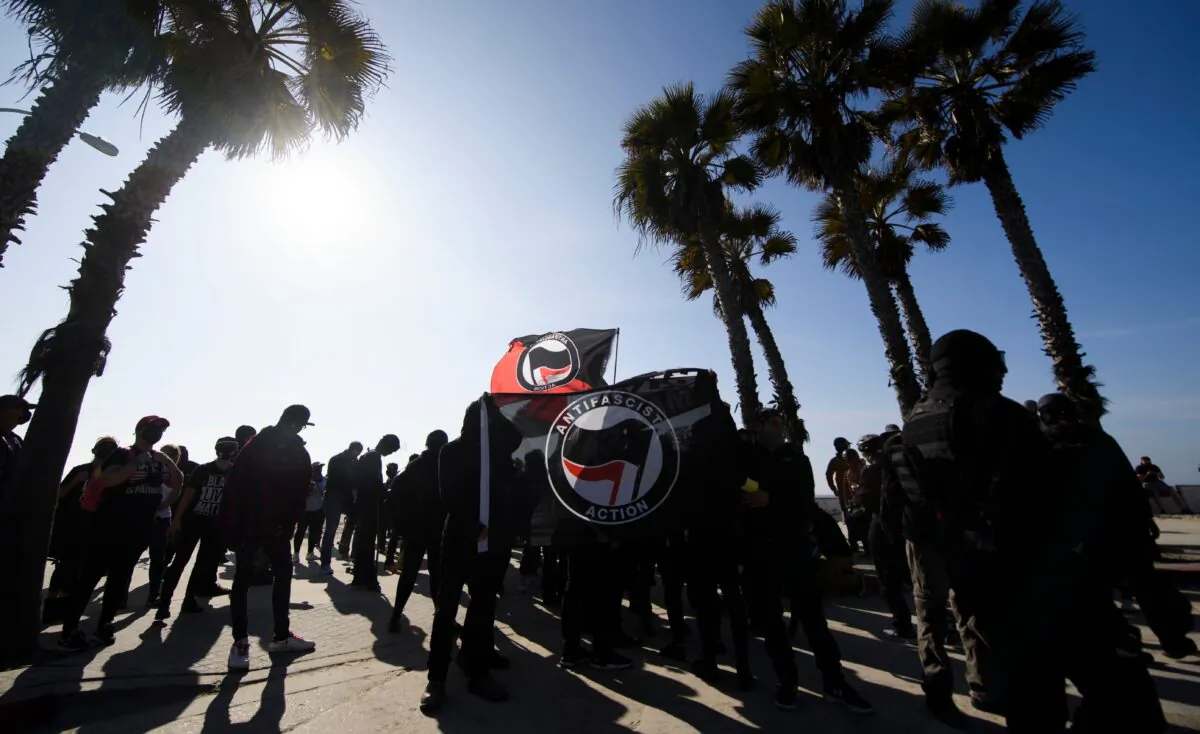 Counter-protesters, some carrying Antifa flags, wait to confront a "Patriot March" demonstration in support of then President Donald Trump in the Pacific Beach neighborhood of San Diego on Jan. 9, 2021. (Patrick T. Fallon/AFP via Getty Images)