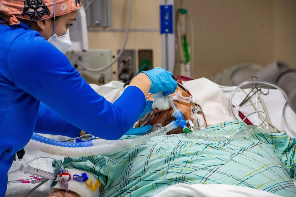 A medical worker treats an intubated unvaccinated 40 year old patient who is suffering from the effects of Covid-19 in the ICU at Hartford Hospital in Hartford, Connecticut on January 18, 2022. (Photo by Joseph Prezioso / AFP) (Photo by JOSEPH PREZIOSO/AFP via Getty Images)