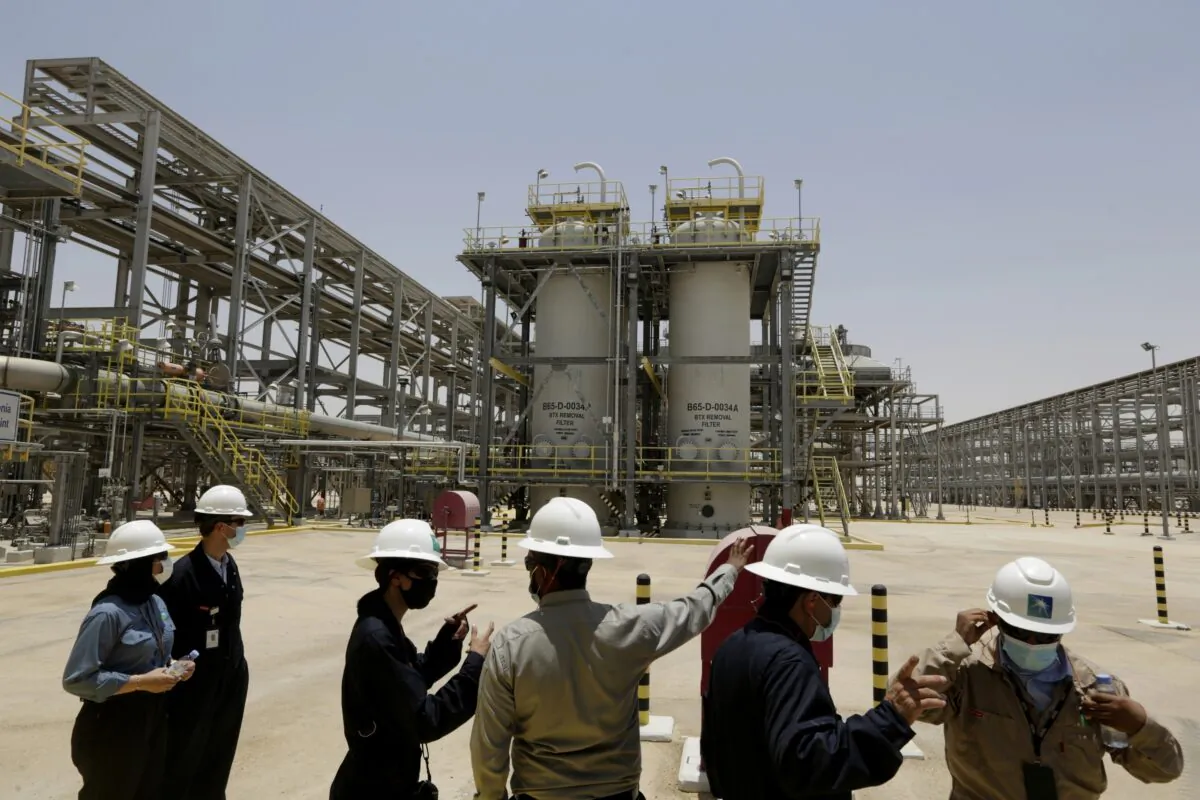 Saudi Aramco engineers and journalists look at the Hawiyah Natural Gas Liquids Recovery Plant in Hawiyah, in the Eastern Province of Saudi Arabia on June 28, 2021. (Amr Nabil/AP Photo)