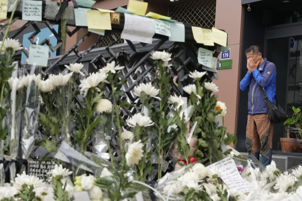 A man weeps as he pays tribute to victims of a deadly accident following Saturday night's Halloween festivities on a street near the scene in Seoul, South Korea, on Nov. 1, 2022. (Ahn Young-joon/AP Photo)