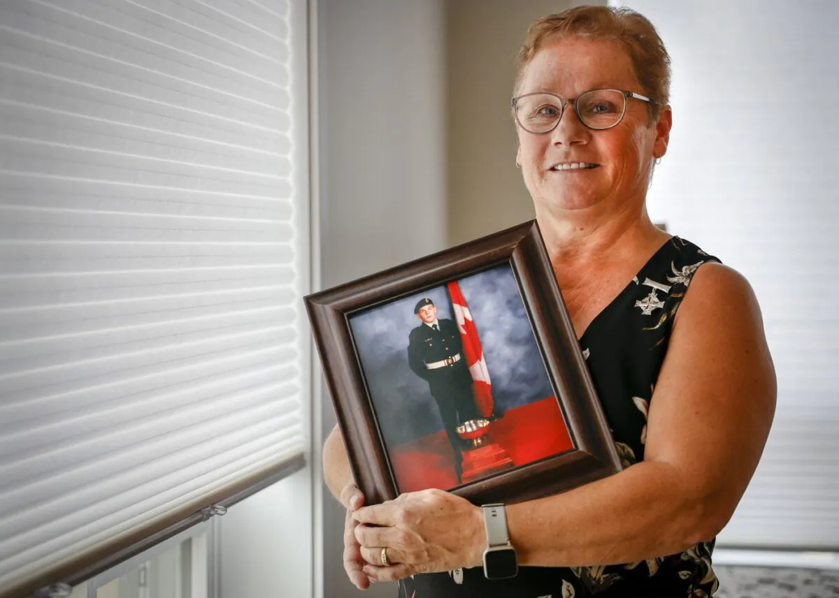 National Silver Cross Mother Candace Greff poses with a picture of her son MCpl. Byron Greff, who was the last soldier to die in Afghanistan, at her home in Lacombe, Alta., Oct. 25, 2022. (The Canadian Press/Jeff McIntosh)
