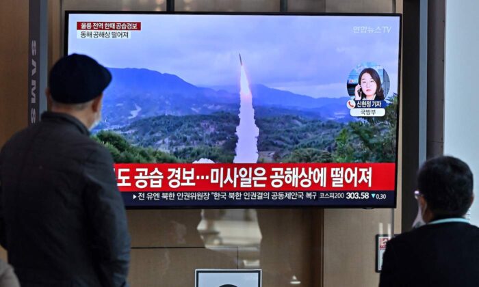 People watch a television screen showing a news broadcast with file footage of a North Korean missile test, at a railway station in Seoul on Nov. 2, 2022. (Jung Yeon-je/AFP via Getty Images)