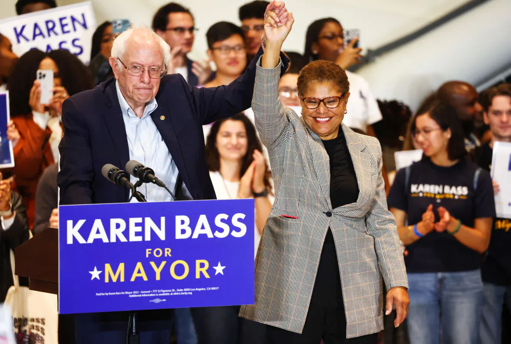 Sen. Bernie Sanders (I-Vt.) joins hands with Los Angeles Democratic mayoral candidate Rep. Karen Bass (D-Calif.) at a campaign rally for Bass in Los Angeles on Oct. 27, 2022. (Mario Tama/Getty Images)