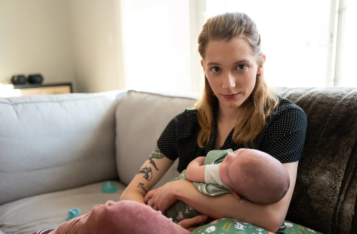 Detransitioner Daisy Strongin holds her infant son in northeastern Illinois on Nov. 1, 2022. (John Fredricks/The Epoch Times)