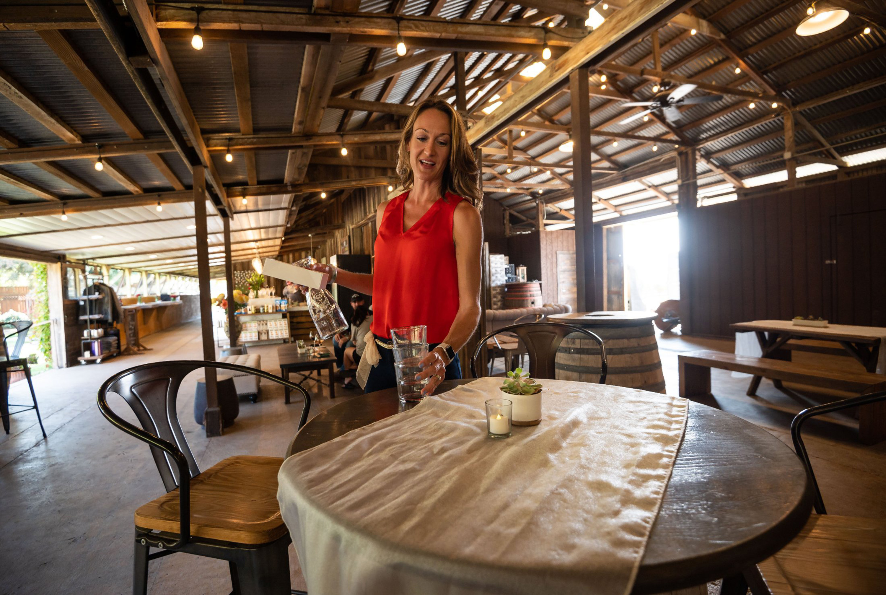 Shannon Ogilvie, hospitality director and tasting room manager, clears a table in the tasting room at Silt Wine Company 